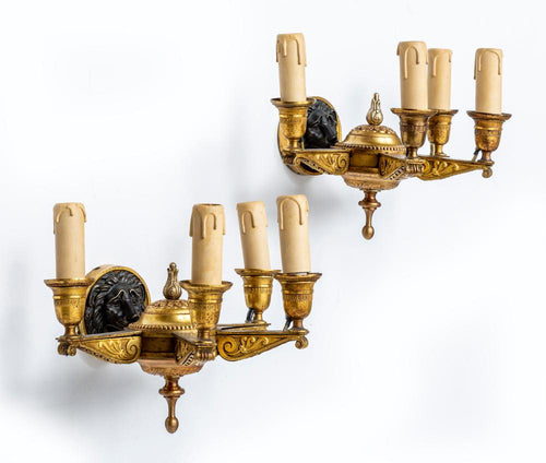 A fine quality pair of Lions head design, four branch gilt bronze Empire wall lights, French early 19th Century
