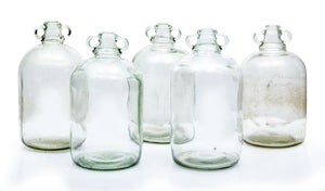 A collection of five clear glass cider bottles English Circa 1900