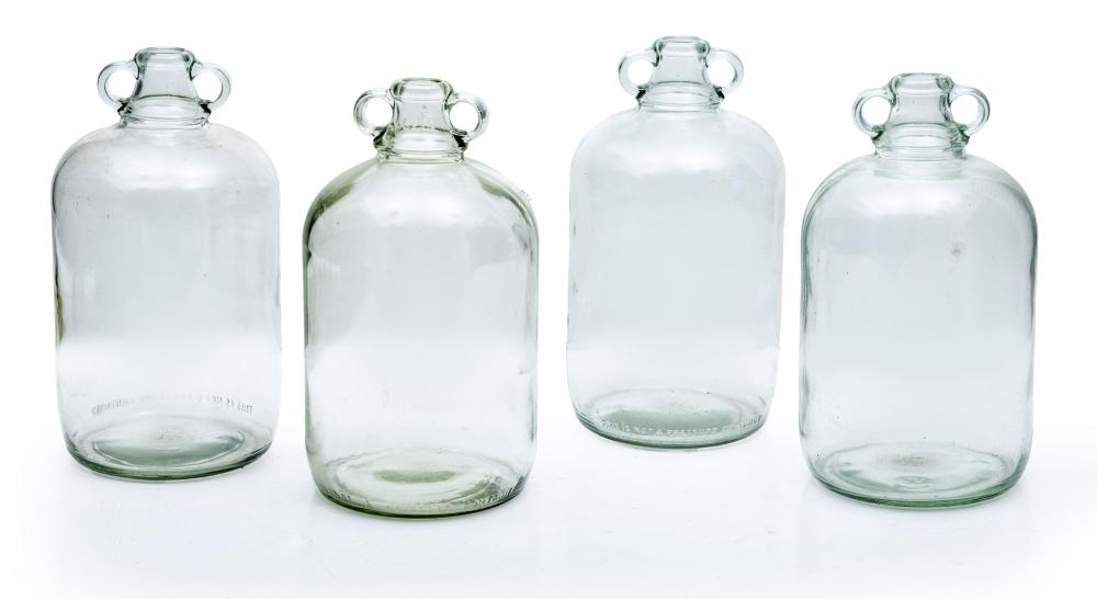 A collection of four clear glass cider bottles, English Circa 1900