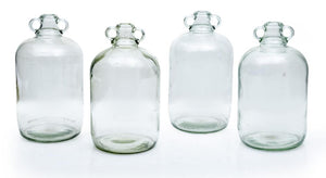 A collection of four clear glass cider bottles, English Circa 1900