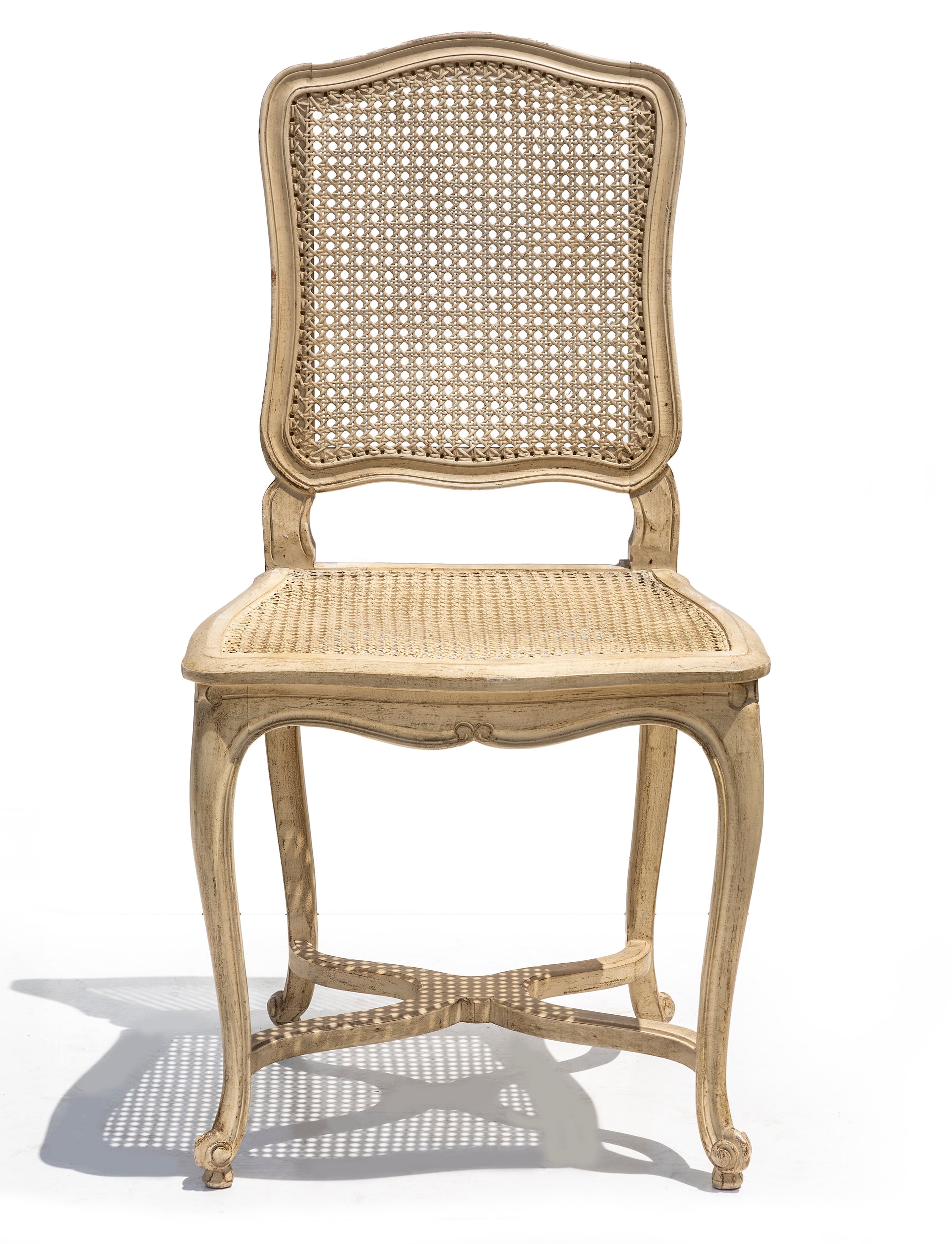 SOLD A stylish set of six white painted cane dining chairs, French Circa 1950