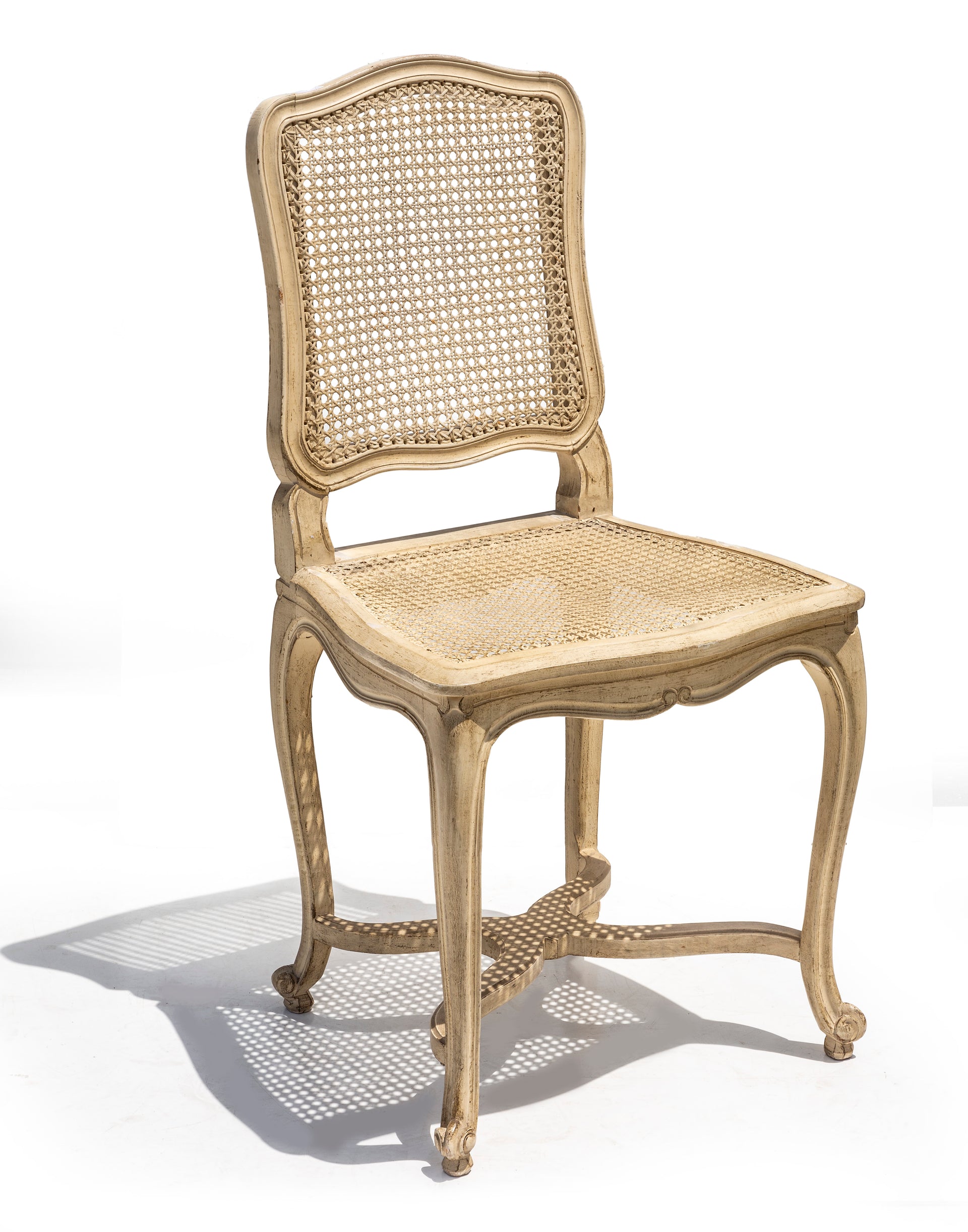 SOLD A stylish set of six white painted cane dining chairs, French Circa 1950