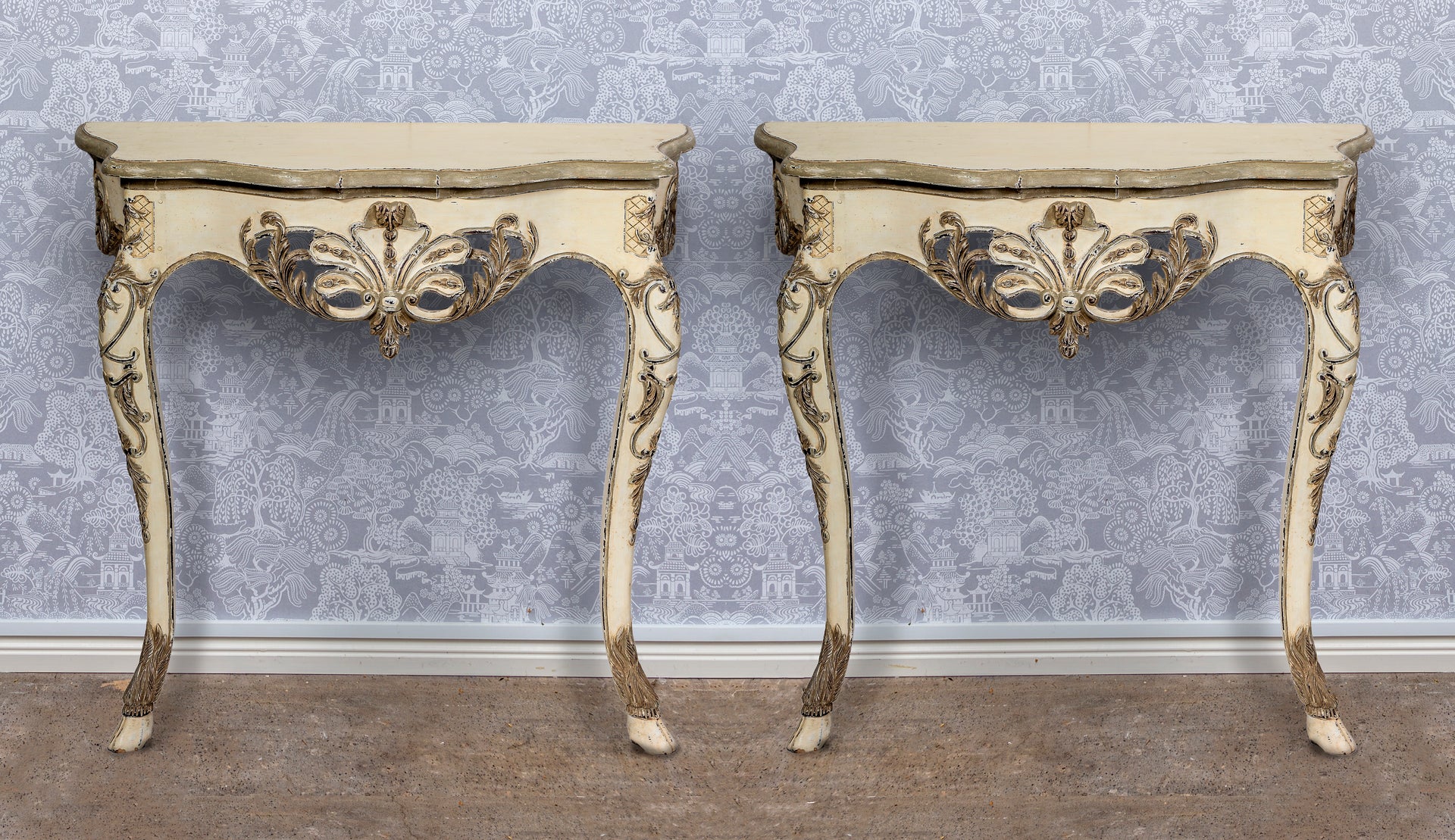 SOLD A highly decorative pair of serpentine fronted gilt painted and carved console tables, French Circa 1950