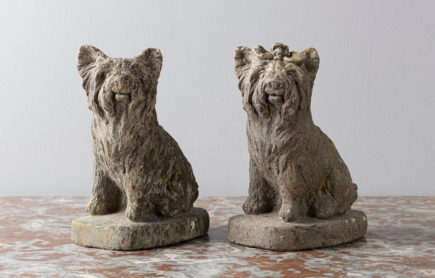 SOLD A pair of reconstituted stone seated French terriers