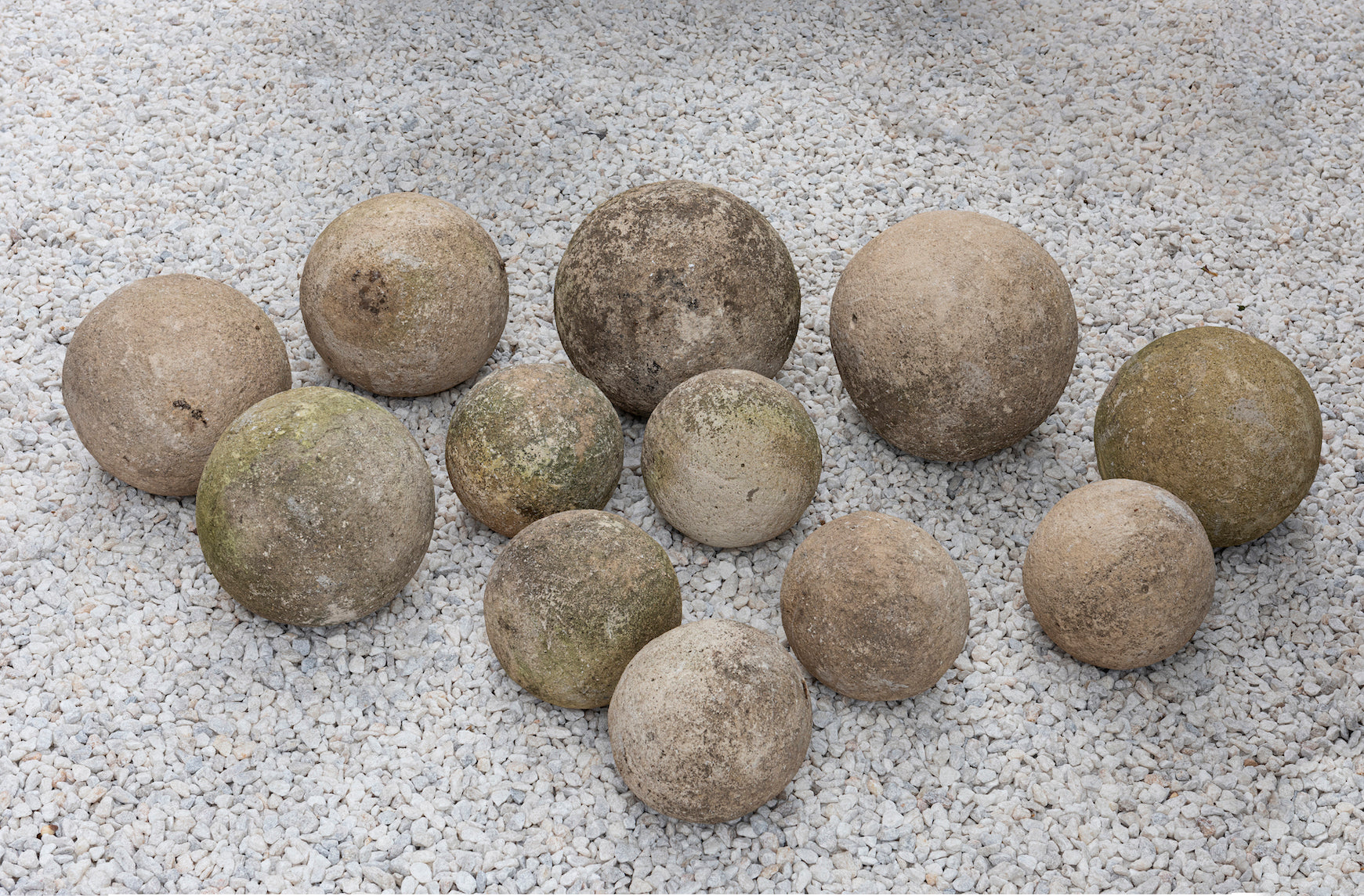 Five pairs of varying sized carved sandstone garden spheres, French 19th Century
