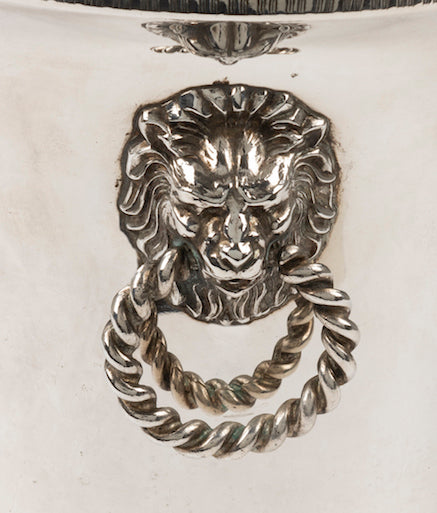 SOLD A silver plated circular wine cooler with lion mask ring handles, French Circa 1950