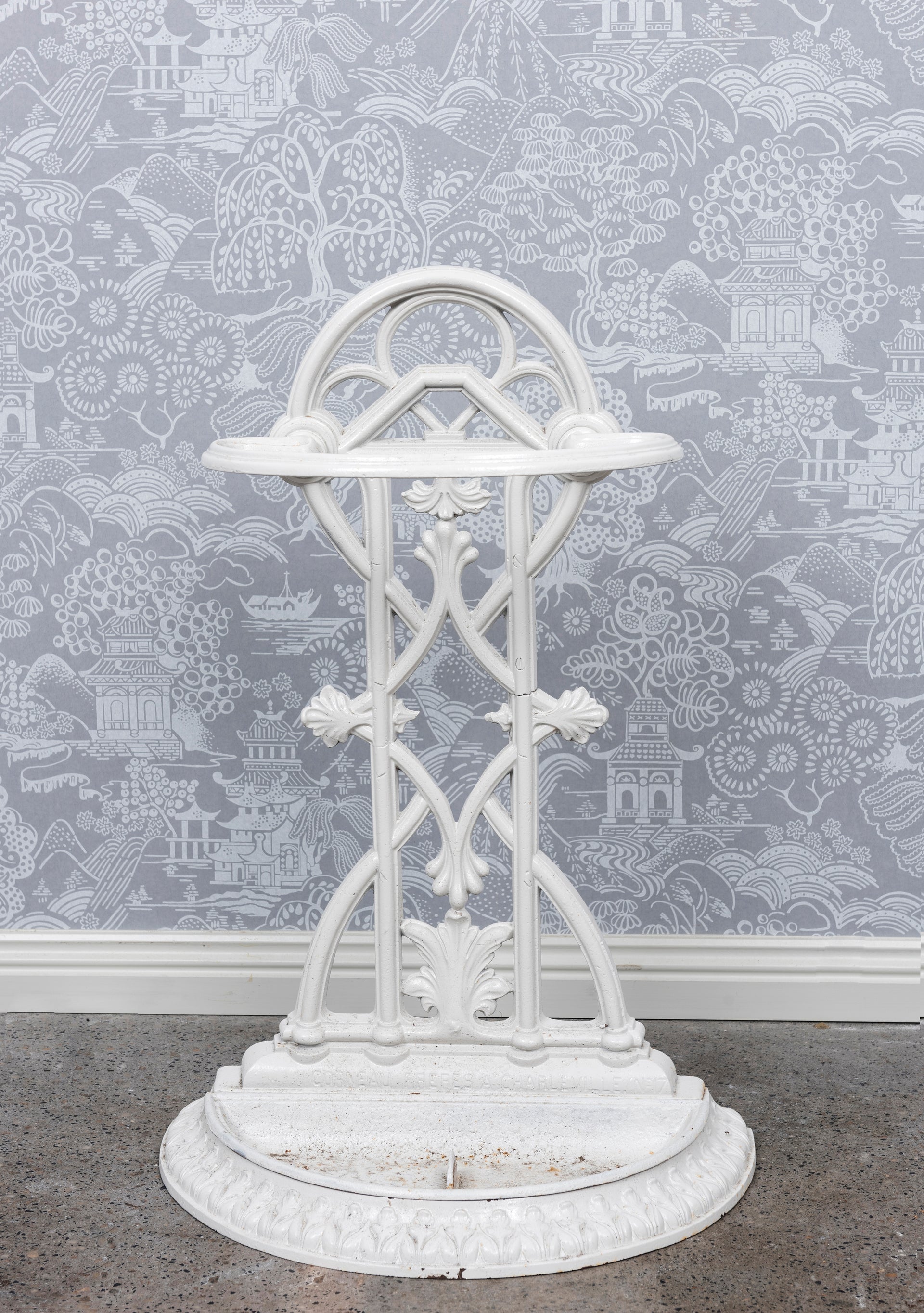 SOLD A decorative white painted demi lune cast iron umbrella stand, French 19th Century