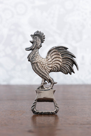 A vintage Spanish metal bottle opener in the form of a cockerel