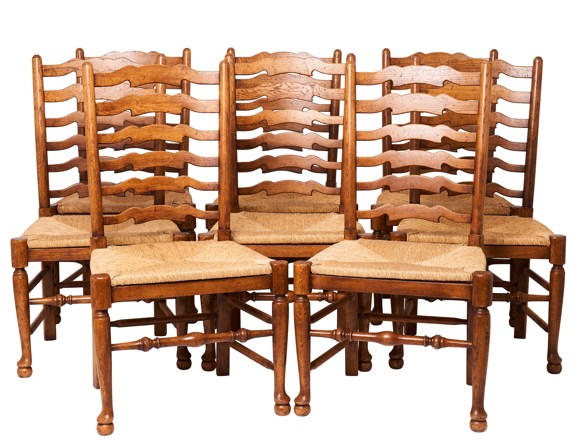 SOLD A set of eight ladder back French oak and rush seated dining chairs