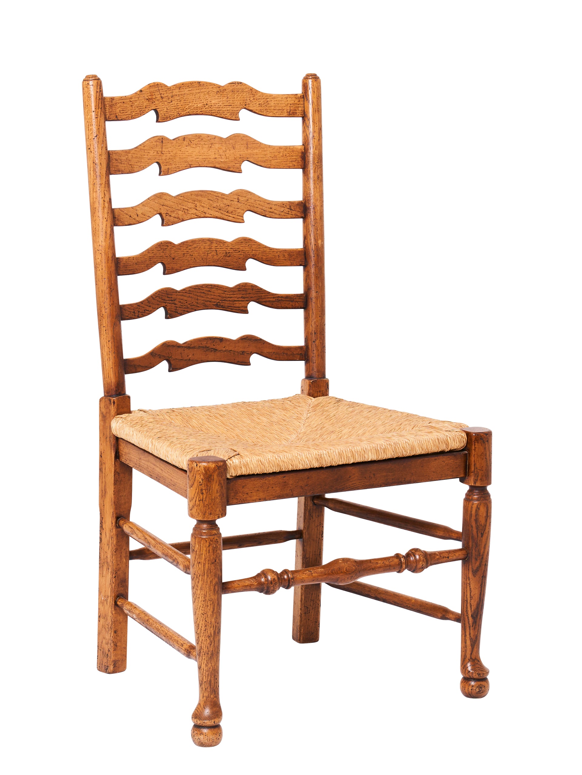 SOLD A set of eight ladder back French oak and rush seated dining chairs