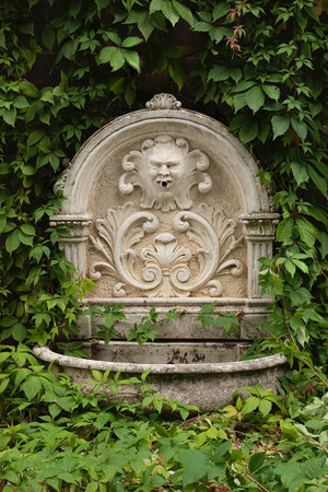 SOLD An impressive carved French stone demi-lune classical wall fountain and font