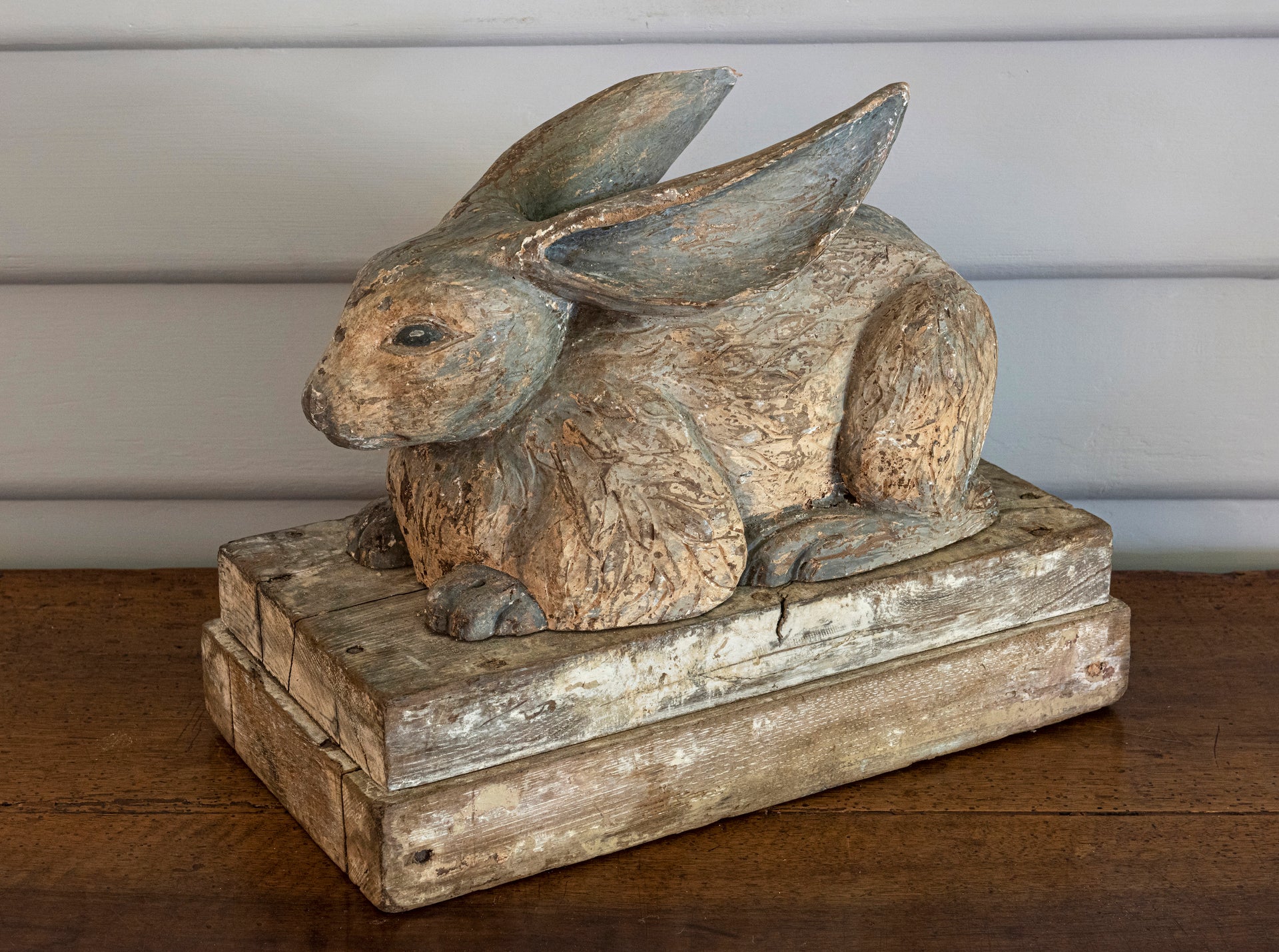 SOLD A polychrome painted and carved wood recumbent rabbit on a stand, Italian 19th Century