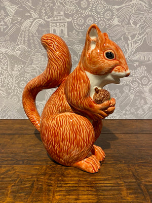 SOLD An earthenware pitcher in the form of a red squirrel holding an acorn by Bordallo Pinheiro, Portugal