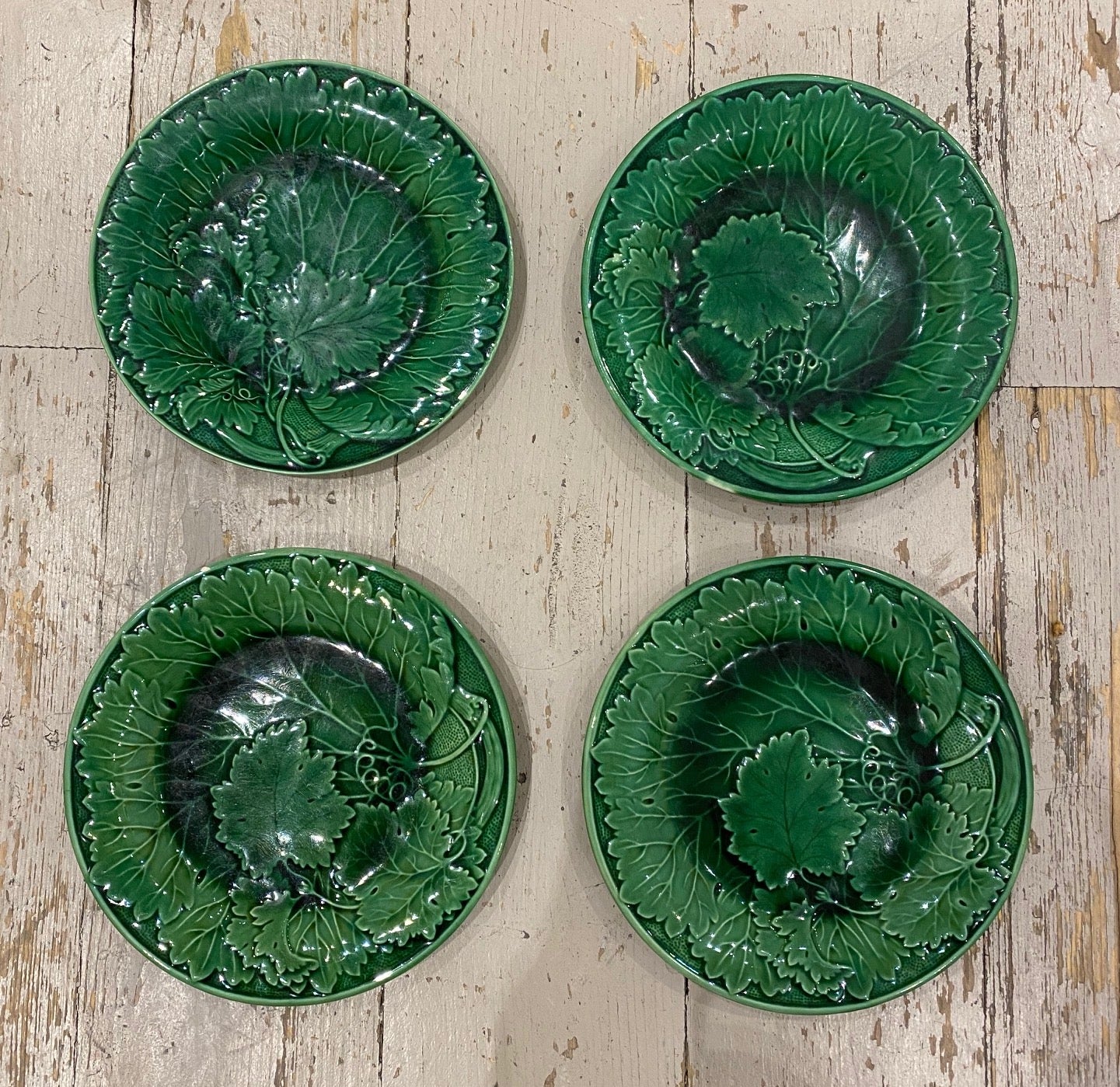 SOLD A set of four green vine leaf faience plates, French Circa 1900