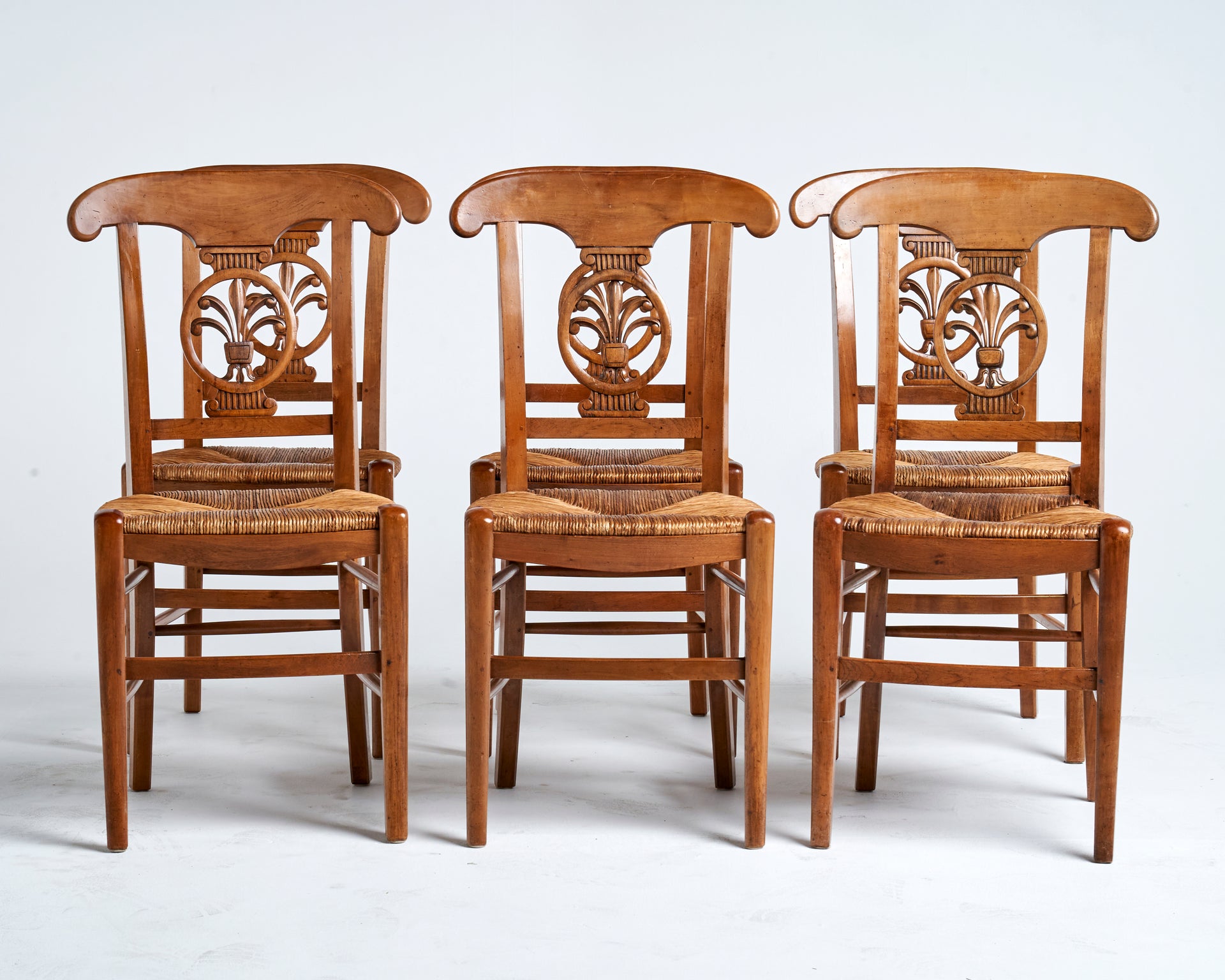 SOLD A uniquely carved set of six solid cherrywood and rush seated chairs, French 19th Century